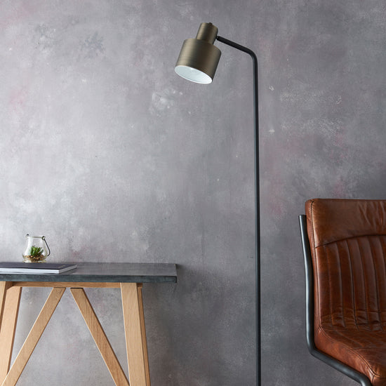 A Mayfield Floor Lamp paired with a leather chair, creating a stylish interior decor statement from Kikiathome.co.uk.
