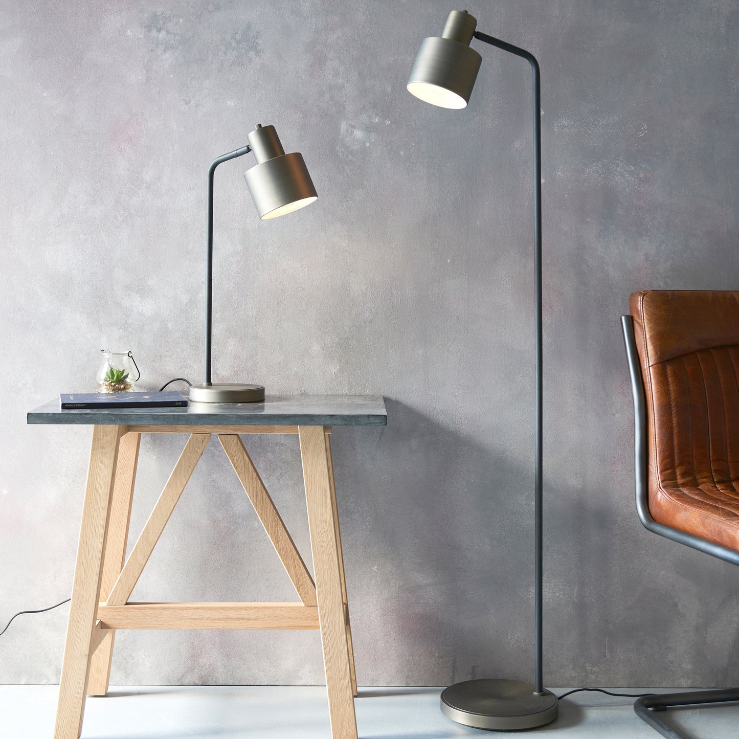 A table with a leather chair and a Mayfield Floor Lamp for interior decor.