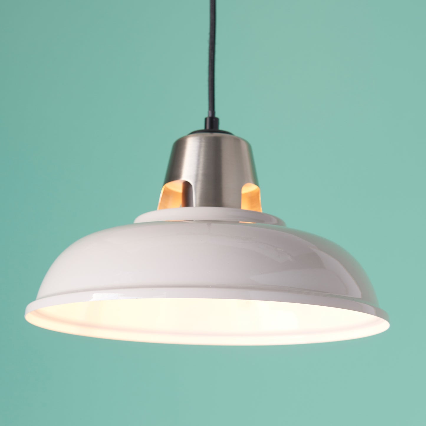 A white Staverton Shade Taupe pendant light hanging on a turquoise background, adding elegance to your interior decor.