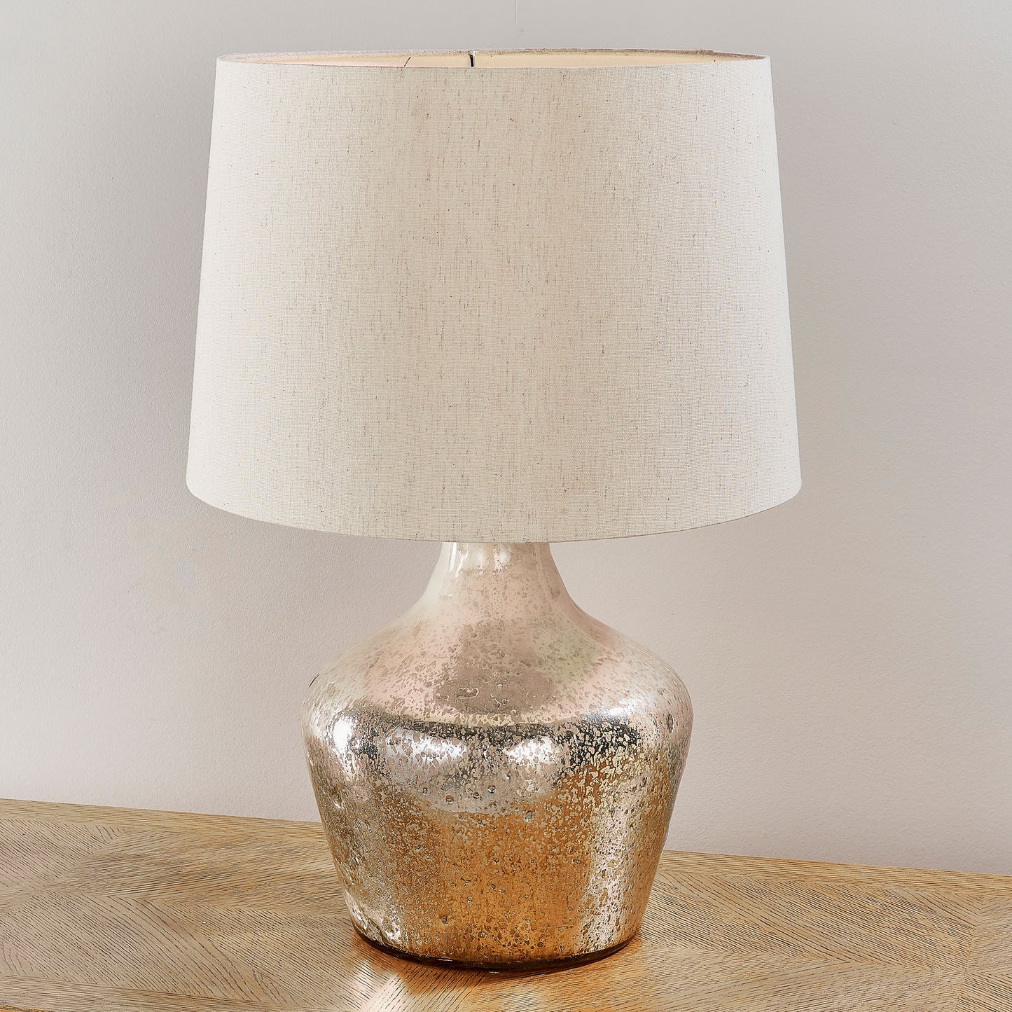 A Meteora 1 Table Light with a beige shade for interior decor.