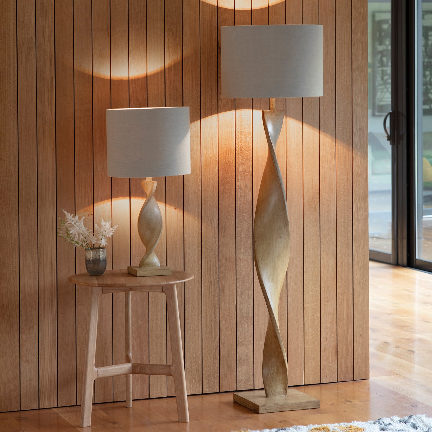 Two Ash Floor Lamps from Kikiathome.co.uk adorning an interior wooden wall.