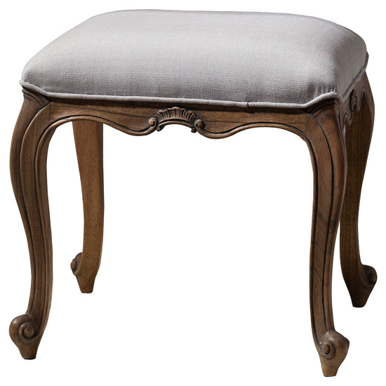 A weathered Holne Dressing Stool with linen upholstery, perfect for interior decor and home furniture.