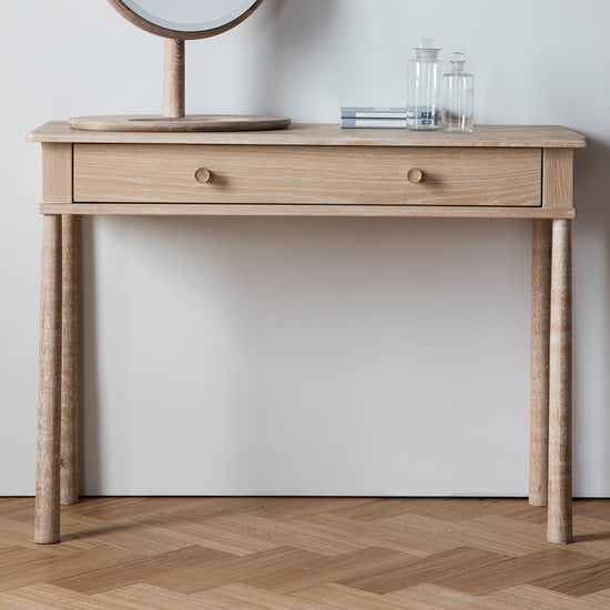 A wooden dressing table with mirror and drawer, perfect for interior decor in any home.