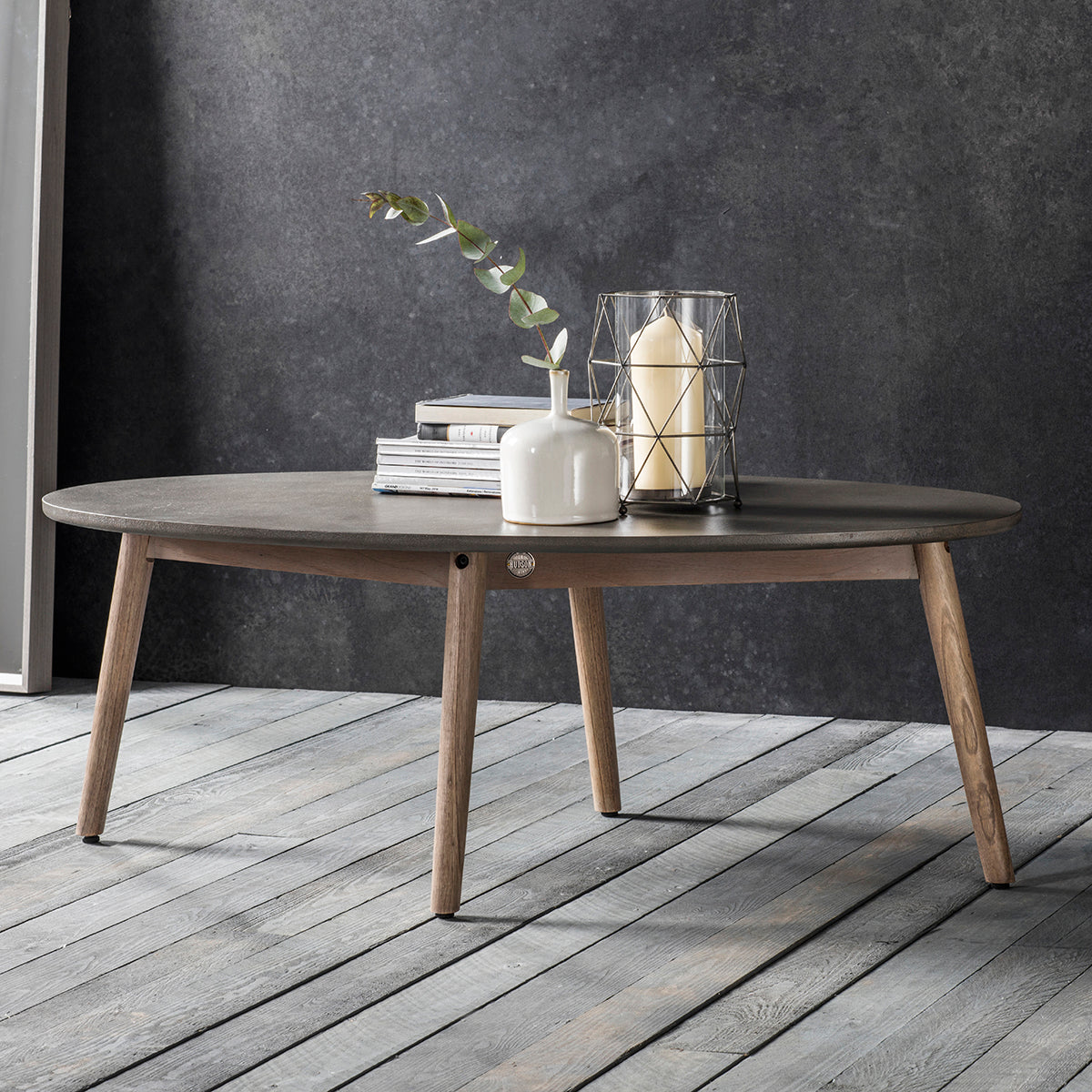 A Kikiathome.co.uk oval coffee table placed on a wooden floor as part of interior decor/home furniture.