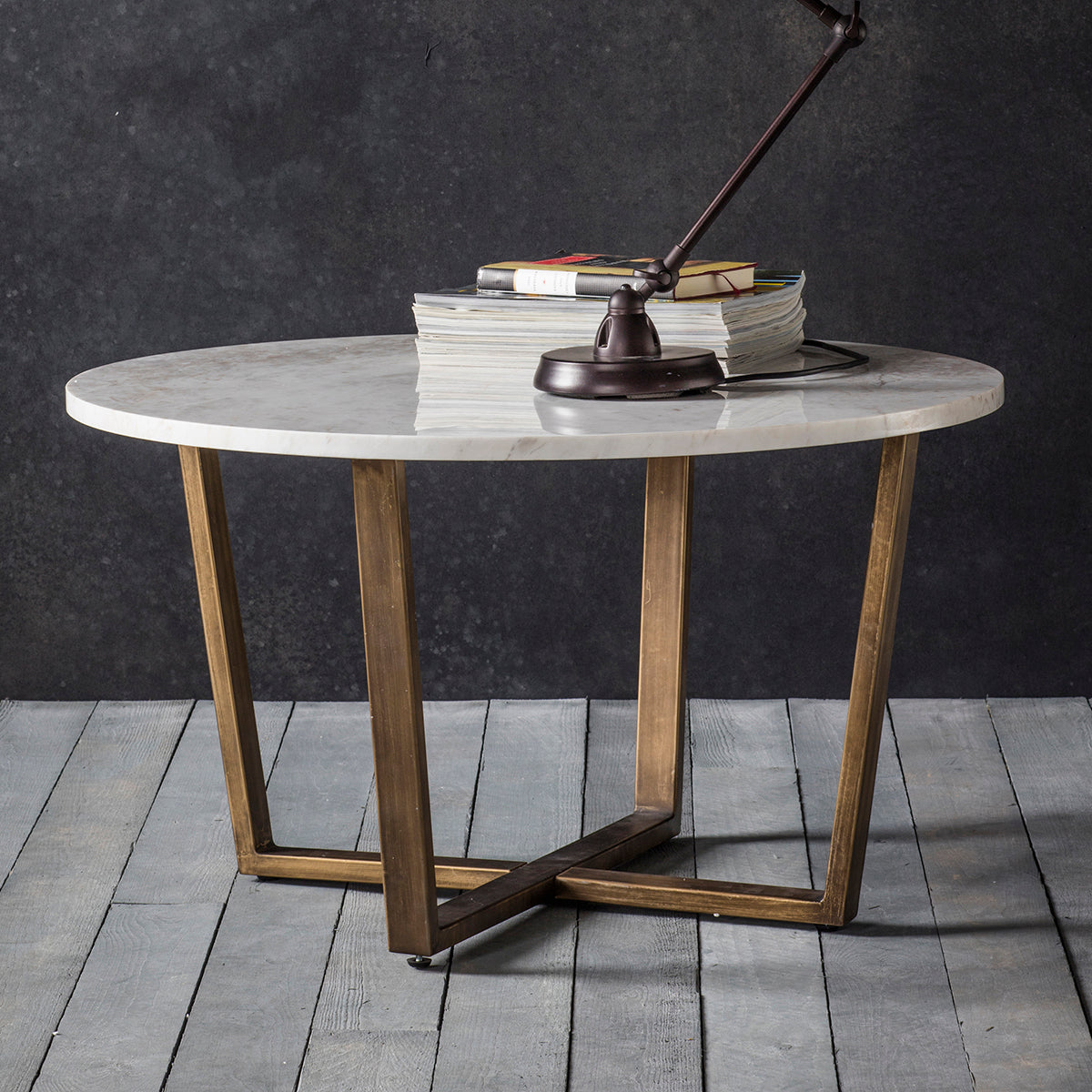 A Hallsand round marble coffee table with wooden legs for interior decor.