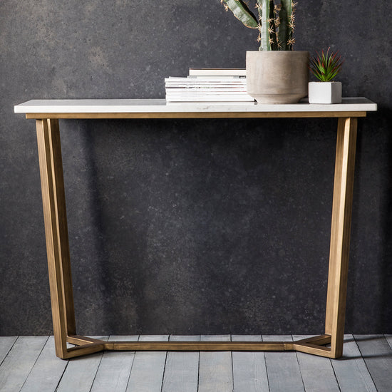 A Hallsand Console Table Marble 1100x400x800mm with a cactus on top for interior decor.