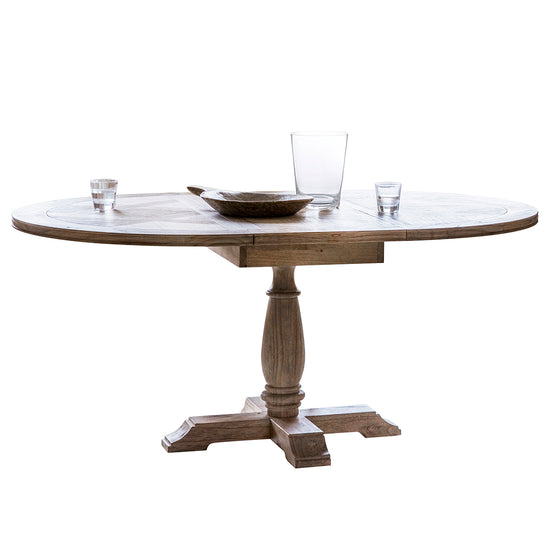 A Belsford Round Extendable Dining Table 1650x1200x750mm with a glass top for interior decor.