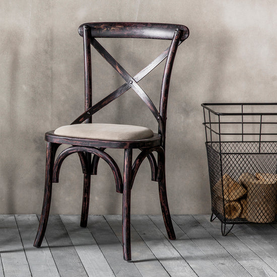 A Cafe Chair Black 460x430x880mm (2pk) enhancing interior decor, next to a basket.