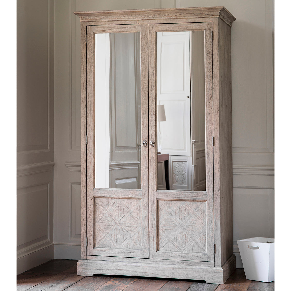 A wooden Belsford 2 Mirror Door Wardrobe 1112x606x1950mm with mirrored doors in a room for interior decor.