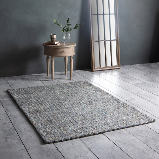 Load image into Gallery viewer, A Brent Rug Stone/Teal 1200x1700mm from Kikiathome.co.uk adding charm to the interior decor of a room with a wooden floor.
