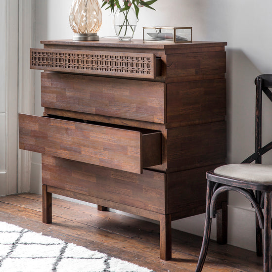 A Dartington Retreat 4 Drawer Chest in a room, perfect for home furniture and interior decor.