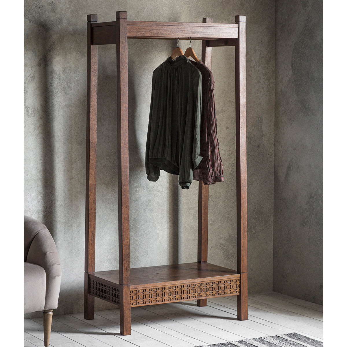 A home furniture piece, the Dartington Retreat Open Wardrobe 800x500x1740mm from Kikiathome.co.uk enhances interior decor with clothes hanging on it.