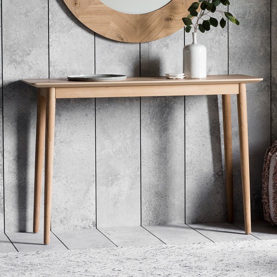 A Tristford console table with a mirror on the wall for your home interior decor from Kikiathome.co.uk.