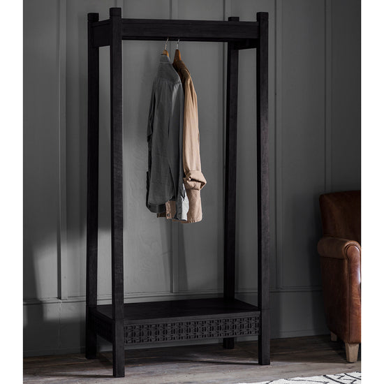 A Dartington Boutique Open Wardrobe 800x500x1740mm from Kikiathome.co.uk stylishly showcases a coat, offering both home furniture and interior decor.