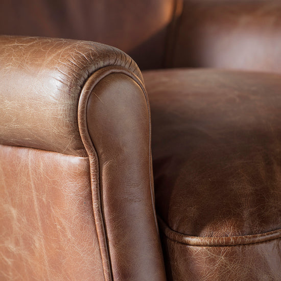 A close up of a Vintage Brown Leather chair from Kikiathome.co.uk, perfect for home furniture and interior decor.