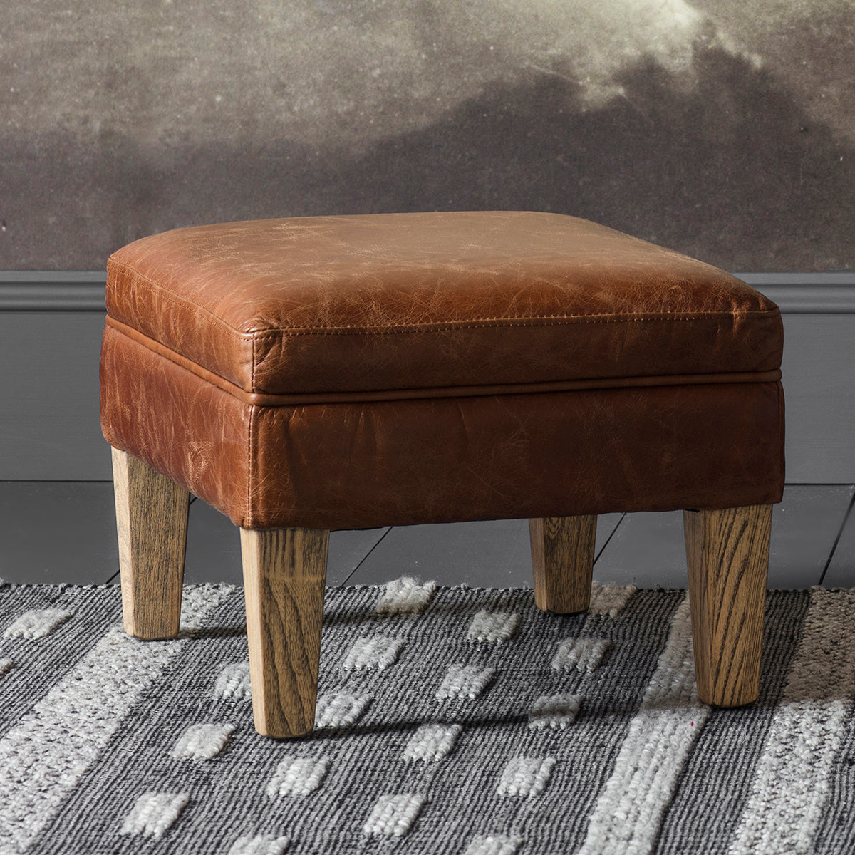 A vintage brown leather ottoman from Kikiathome.co.uk serves as an interior decor statement piece.