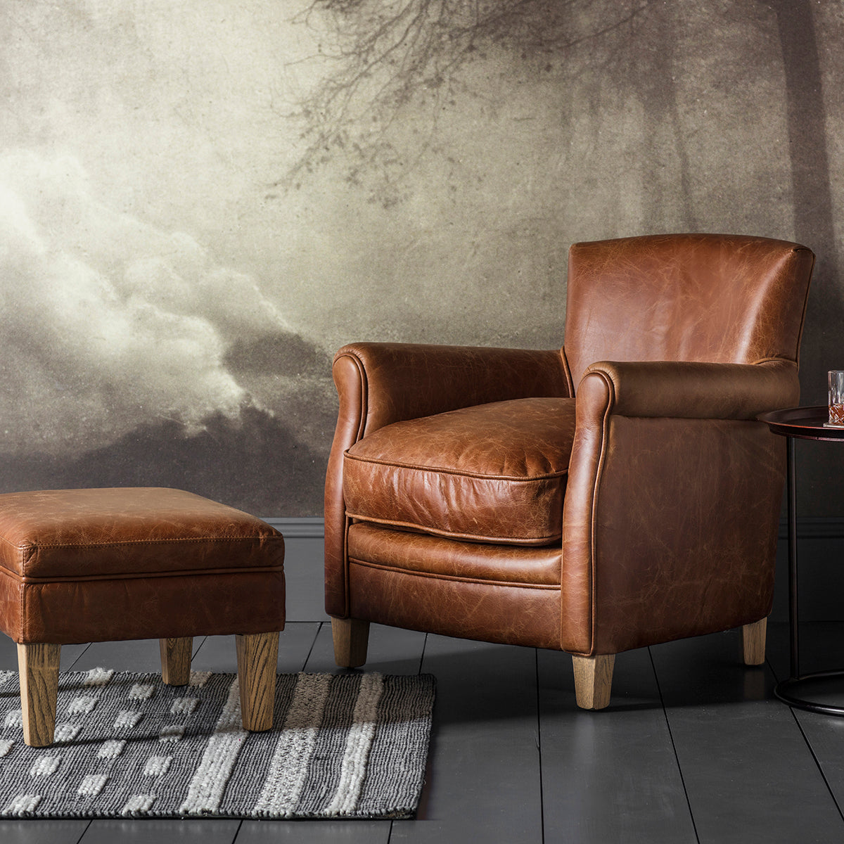 A vintage brown leather chair and ottoman from Kikiathome.co.uk, showcasing home furniture and interior decor, placed in front of a wall.