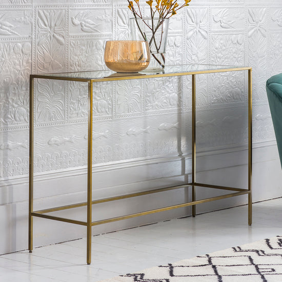 An Engleborne Console Table Bronze 1100x350x760mm for interior decor in front of a white wall.