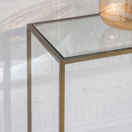 An Engleborne Console Table Bronze 1100x350x760mm with a vase on top from Kikiathome.co.uk, providing stylish home furniture for interior decor.