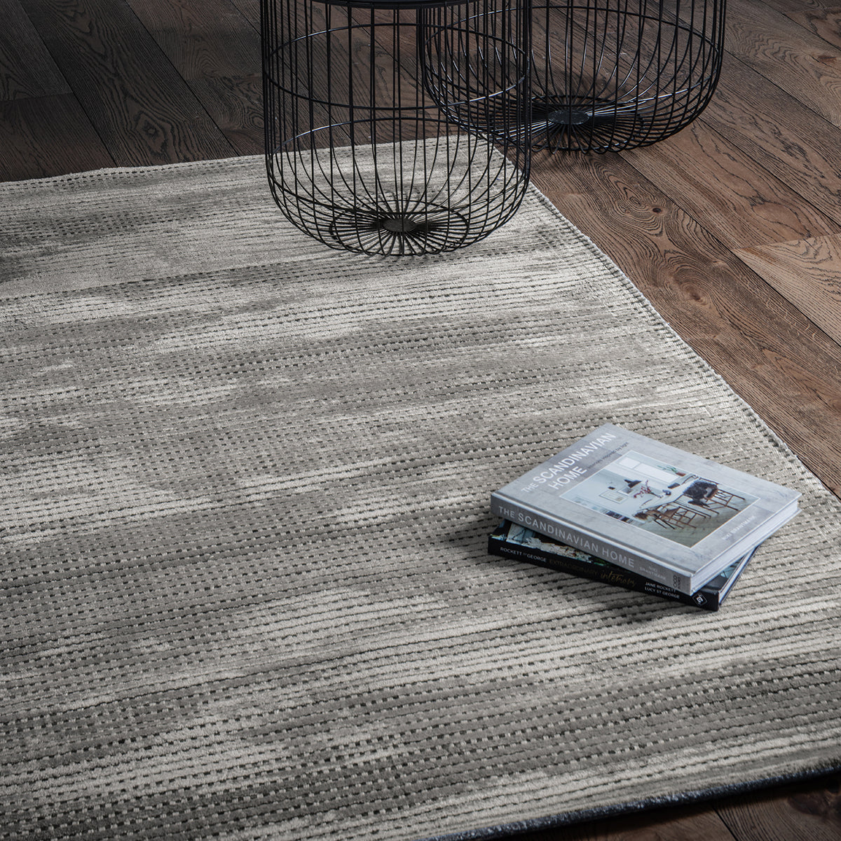 Load image into Gallery viewer, A Sipan rug ash 1600x2300mm, a stylish addition to interior decor, beautifully complements a wooden floor.
