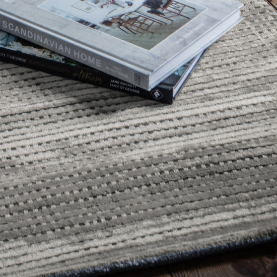 A Sipan Rug Ash 1600x2300mm from Kikiathome.co.uk with interior decor elements.