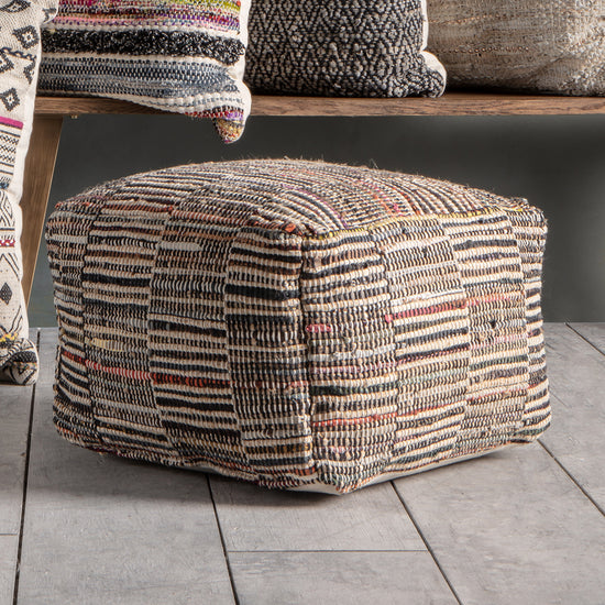 An Aveton Pouffe Multi from Kikiathome.co.uk, a home furniture item, sitting on top of a wooden floor.