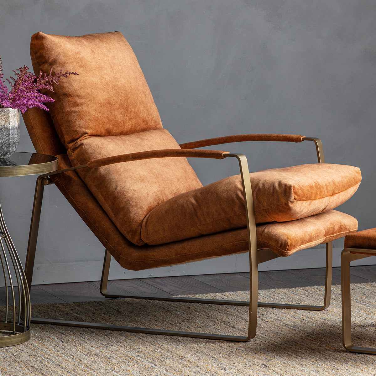 A Huish Lounger Ochre, a home furniture piece by Kikiathome.co.uk, beautifully complements the interior decor alongside an ottoman and coffee table.