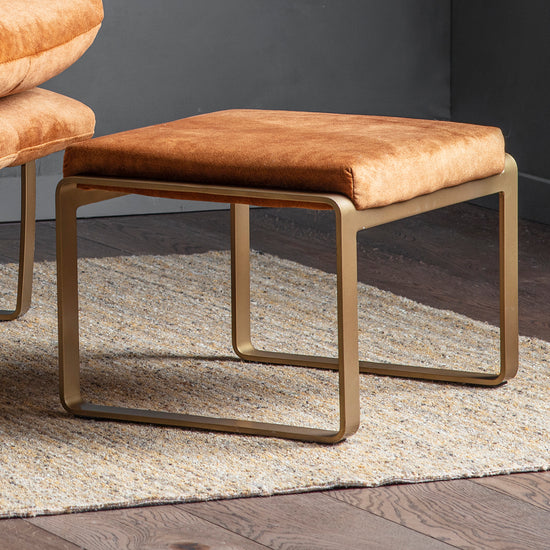 A pair of Huish Footstool Ochre from Kikiathome.co.uk placed on a rug as part of interior decor.