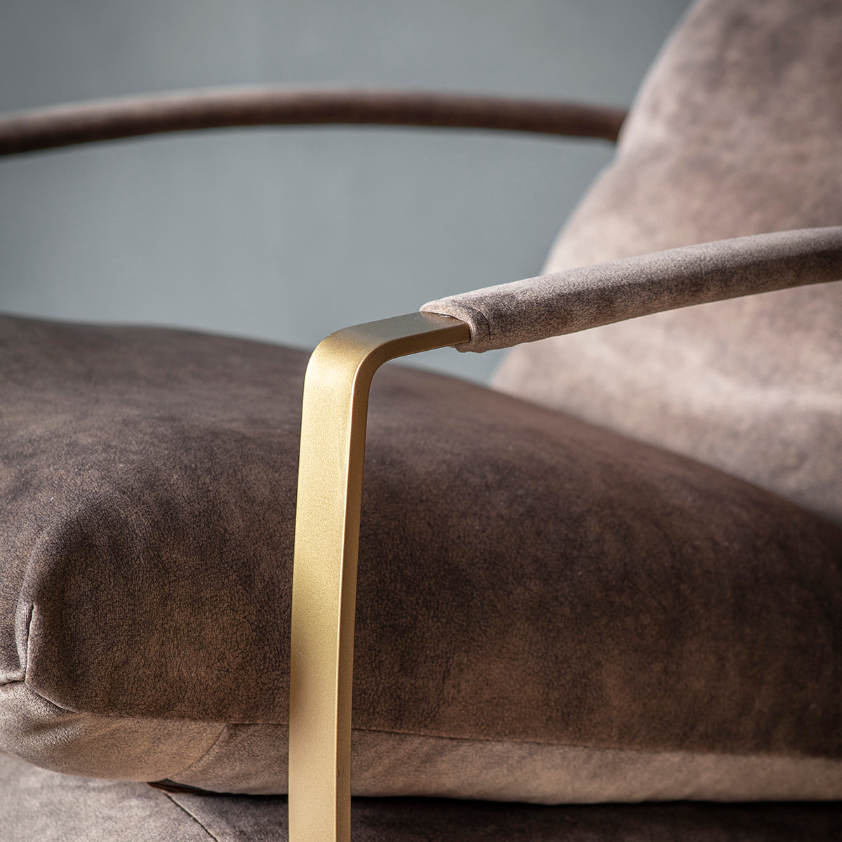 A close up of the Huish Lounger Mineral with a gold frame, perfect for interior decor at home.