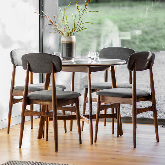 A dining room with stylish home furniture and four chairs, featuring an Avonwick Dining Table Round 900x900x760mm from Kikiathome.co.uk.