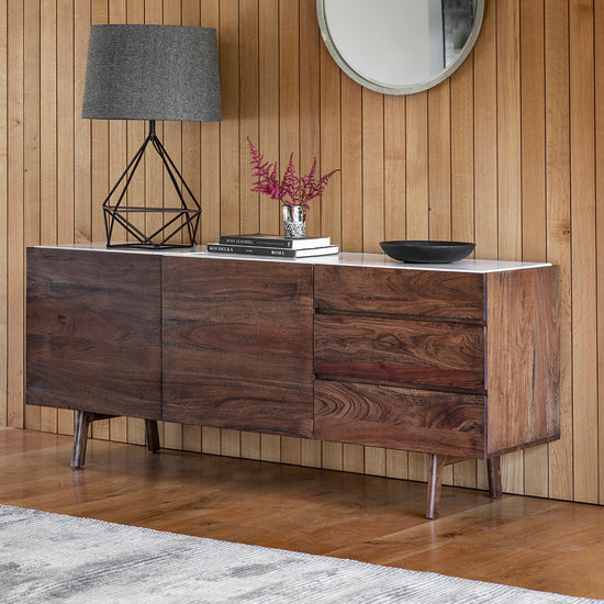 A Avonwick Sideboard 1650x450x700mm in a room with wood paneling, perfect for interior decor and home furniture enthusiasts, from Kikiathome.co.uk.
