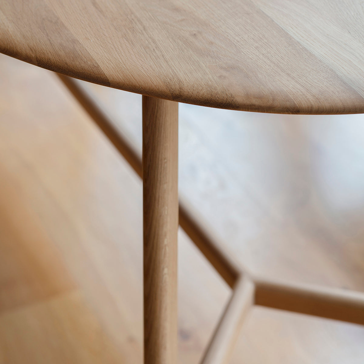 A close up of a 1800x1000x760mm Dairy Oval Dining Table by Kikiathome.co.uk on a wooden floor, perfect for interior decor.