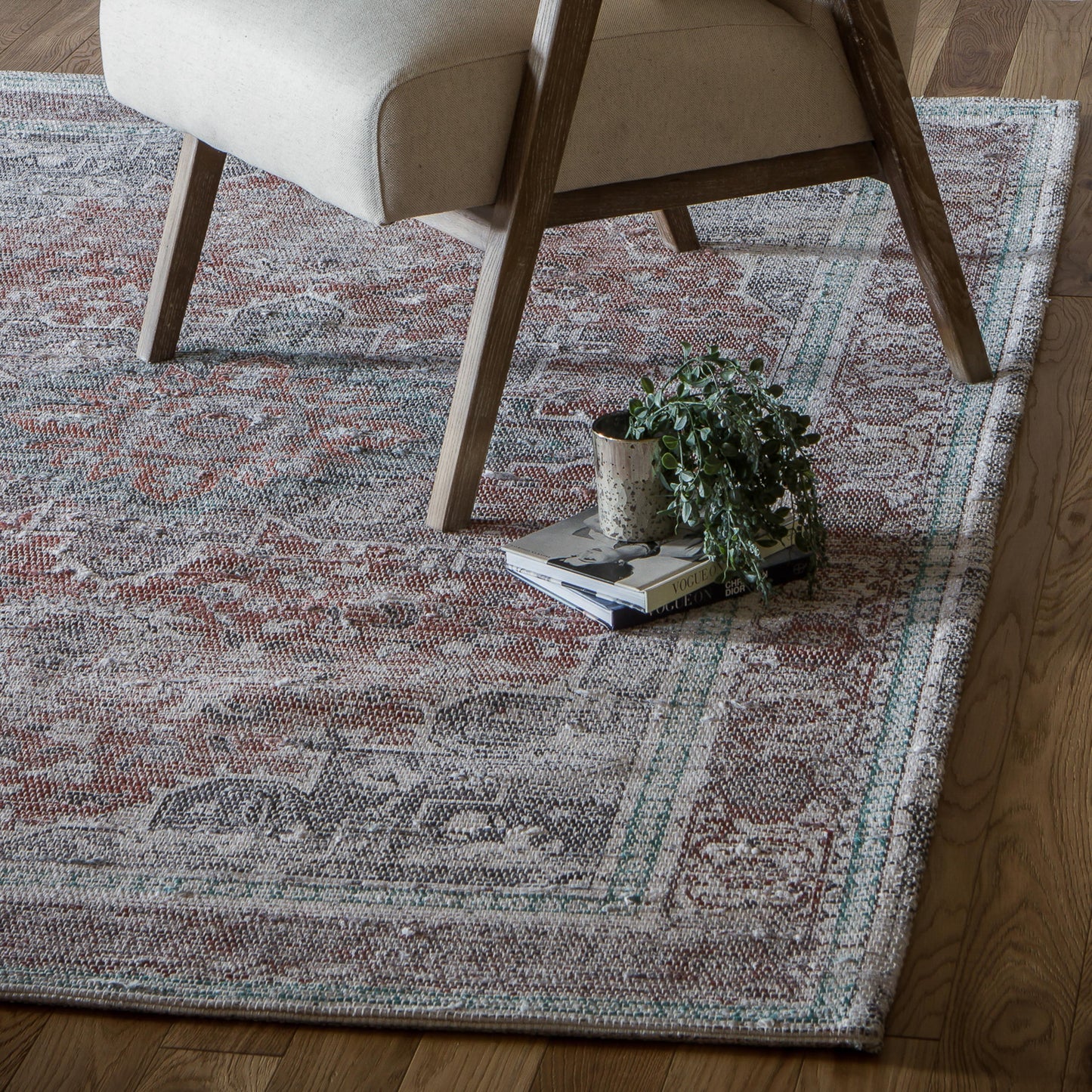 An Allaleigh Rug 1600x2300mm from Kikiathome.co.uk, a home furniture and interior decor addition, in a living room with a chair and a plant.