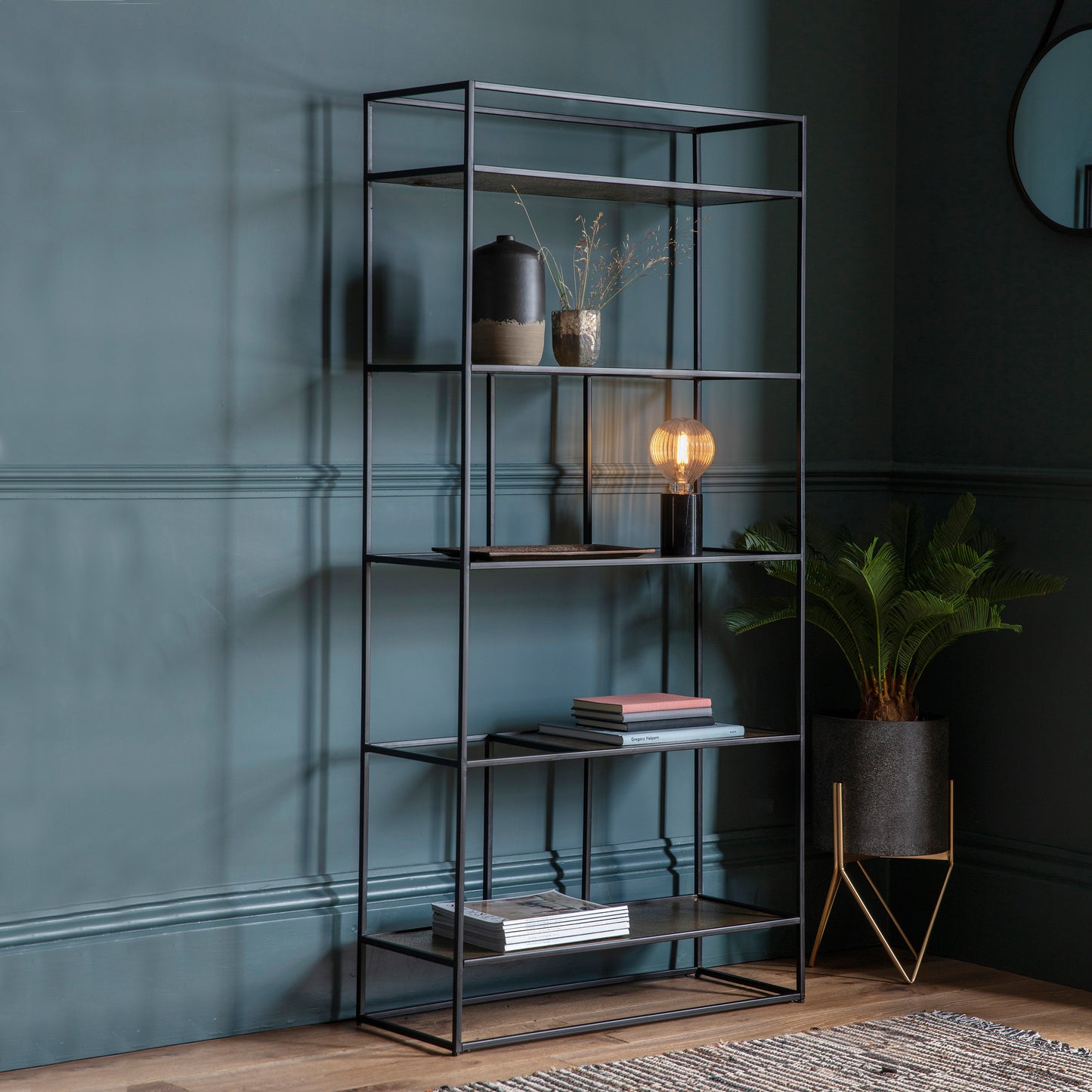 A Home furniture display unit in an antique gold finish by Kikiathome.co.uk showcasing interior decor on blue walls.