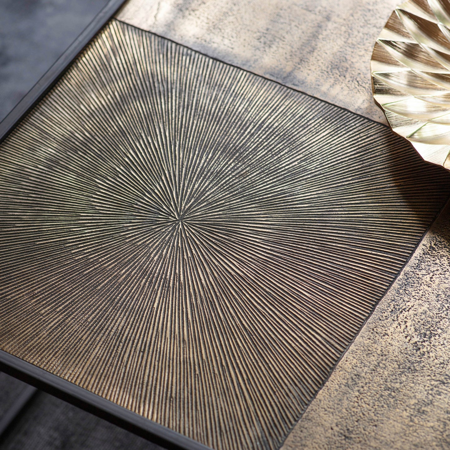 A Bigbury Coffee Table Antique Gold 800x800x400mm with a starburst pattern on it, perfect for home furniture and interior decor.
