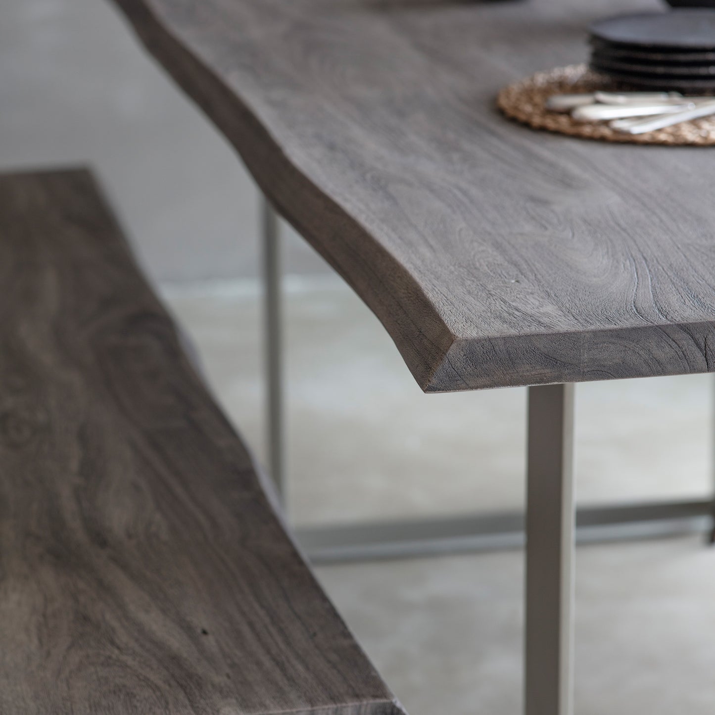 A Southpool Dining Table Grey 2000x1000x770mm with a metal base and a bench, perfect for home furniture and interior decor.