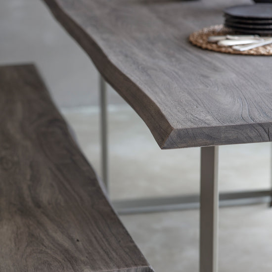 A Southpool Dining Table Grey 2000x1000x770mm with a metal base and a bench, perfect for home furniture and interior decor.