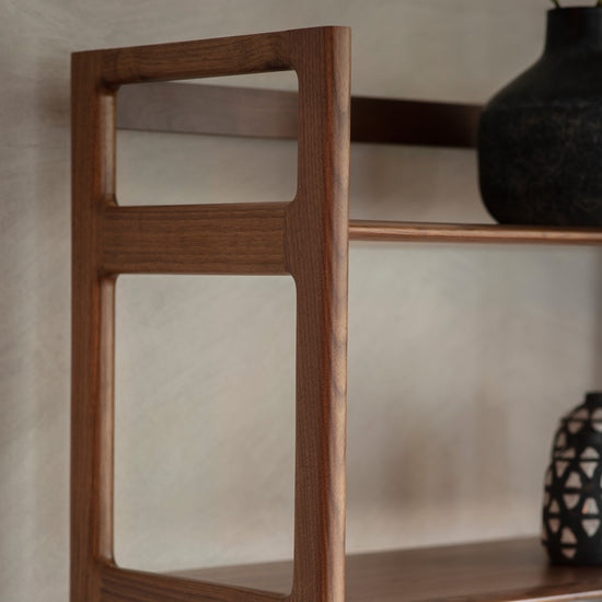 A Walnut shelf with a vase on it for interior decor and home furniture by Kikiathome.co.uk.