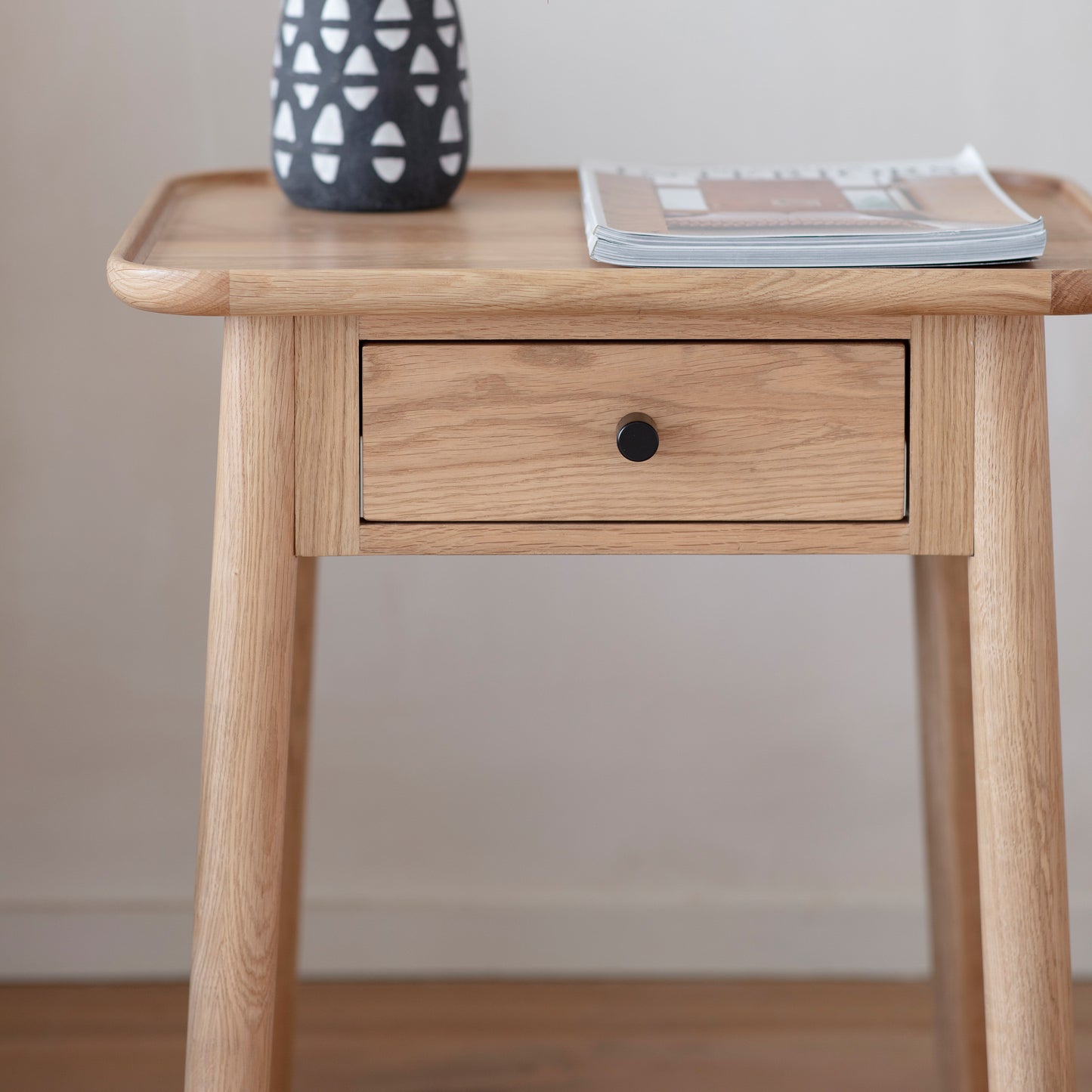 A Wembury 1 Drawer Side Table 500x400x550mm with a drawer and a vase, perfect for interior decor or home furniture, available at Kikiathome.co.uk.