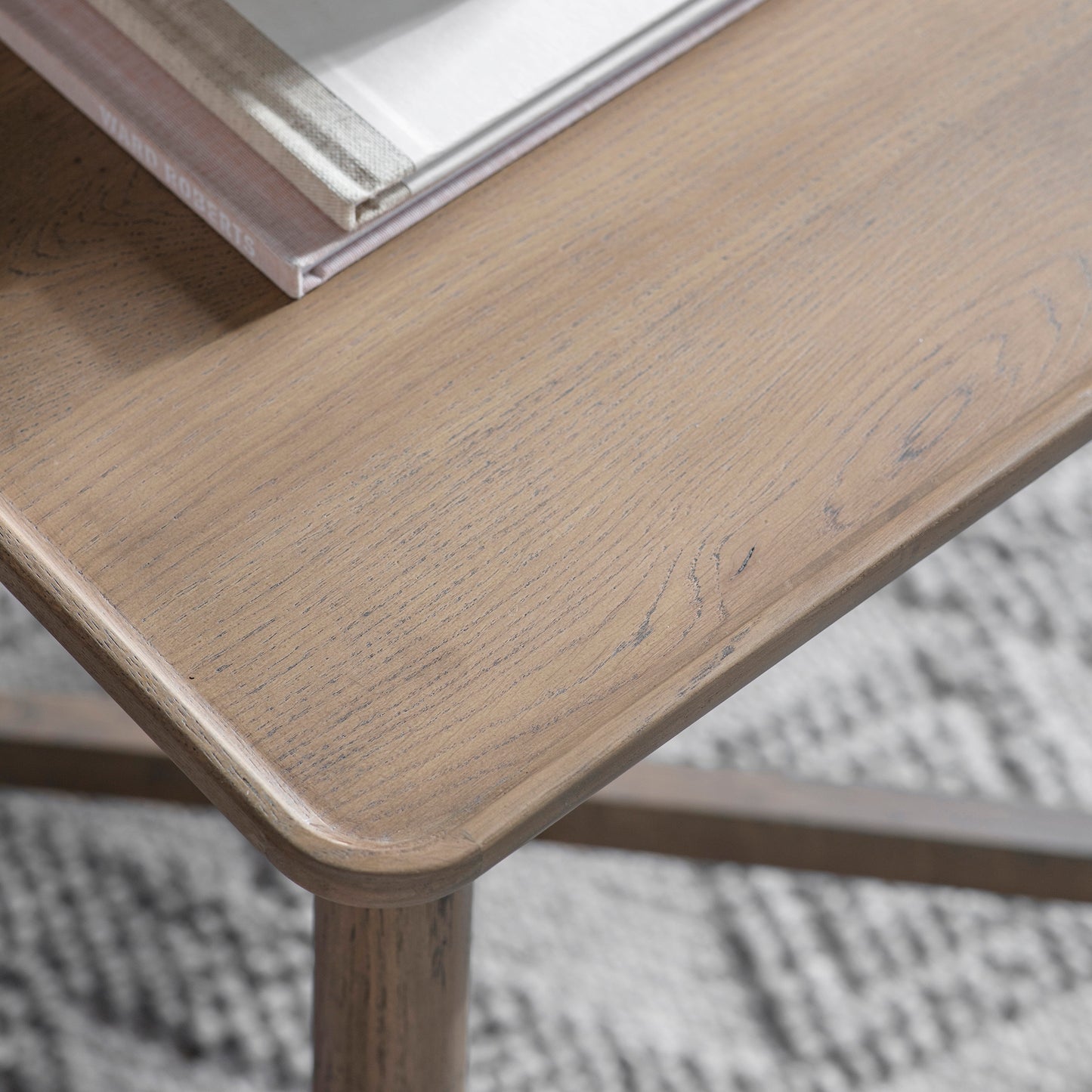 A close up of a Wembury Side Table, a home furniture piece from Kikiathome.co.uk, with a book on it.