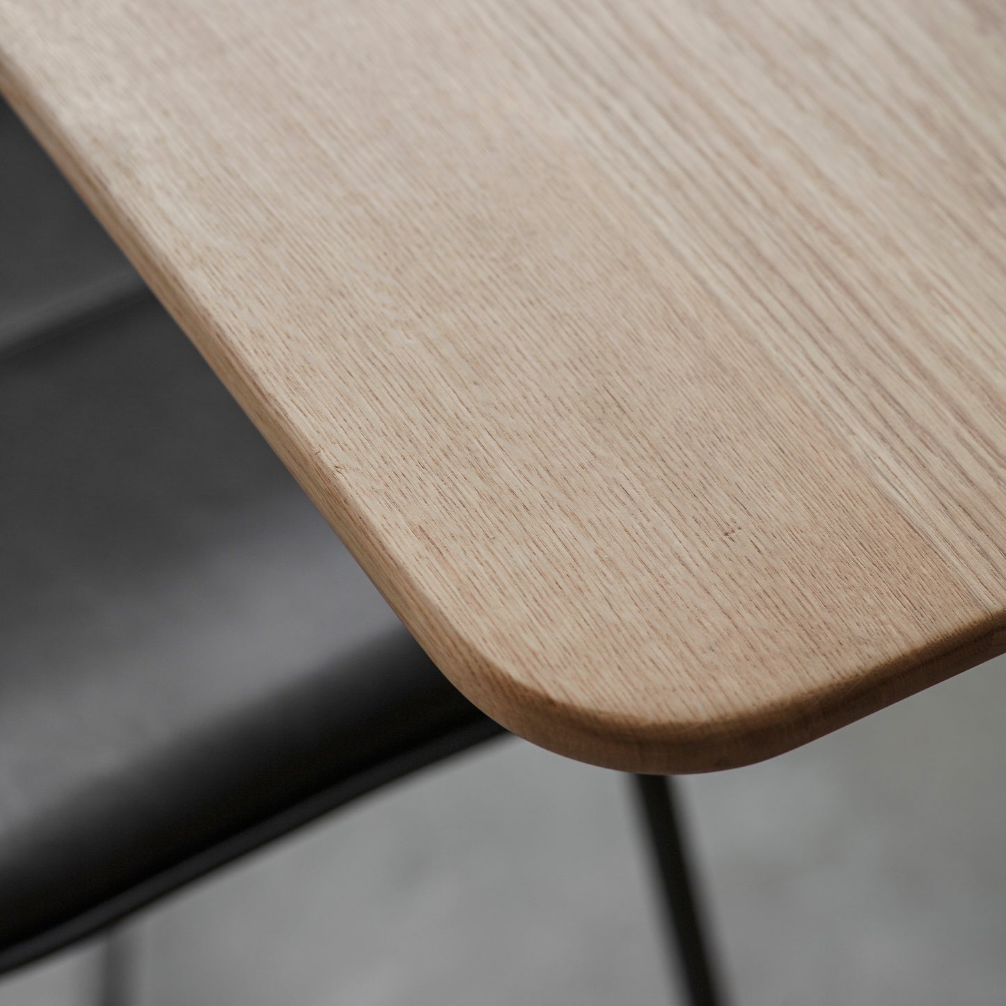 A close up of the Wembury Extendable Dining Table by Kikiathome.co.uk in interior decor setting with black chairs.