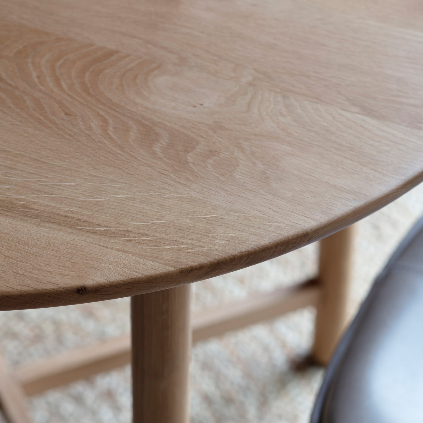 A close up of a Wembury Round Dining Table 900x900x750mm for interior decor.