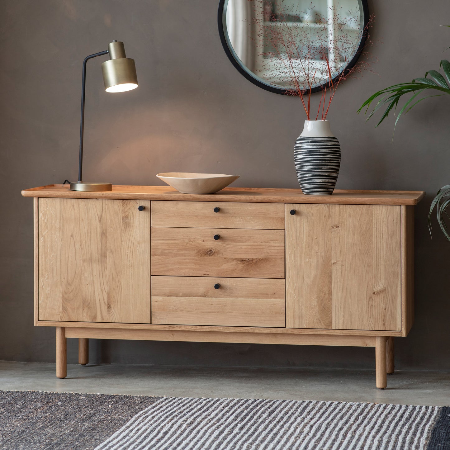 A Wembury 2 Door 3 Drawer Sideboard 1500x450x710mm with drawers and a mirror for your interior decor from Kikiathome.co.uk.