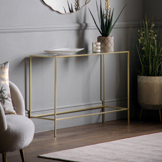 An Engleborne Console Table in Champagne by Kikiathome.co.uk beautifully complements the interior decor of a room with a mirror.