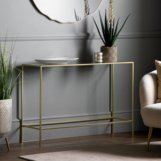 An Engleborne Console Table Champagne 1100x350x760mm by Kikiathome.co.uk, a home furniture piece, situated in a room with a mirror for interior decor.