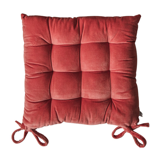 A Coral velvet seatpad with ties for interior decor from Kikiathome.co.uk.