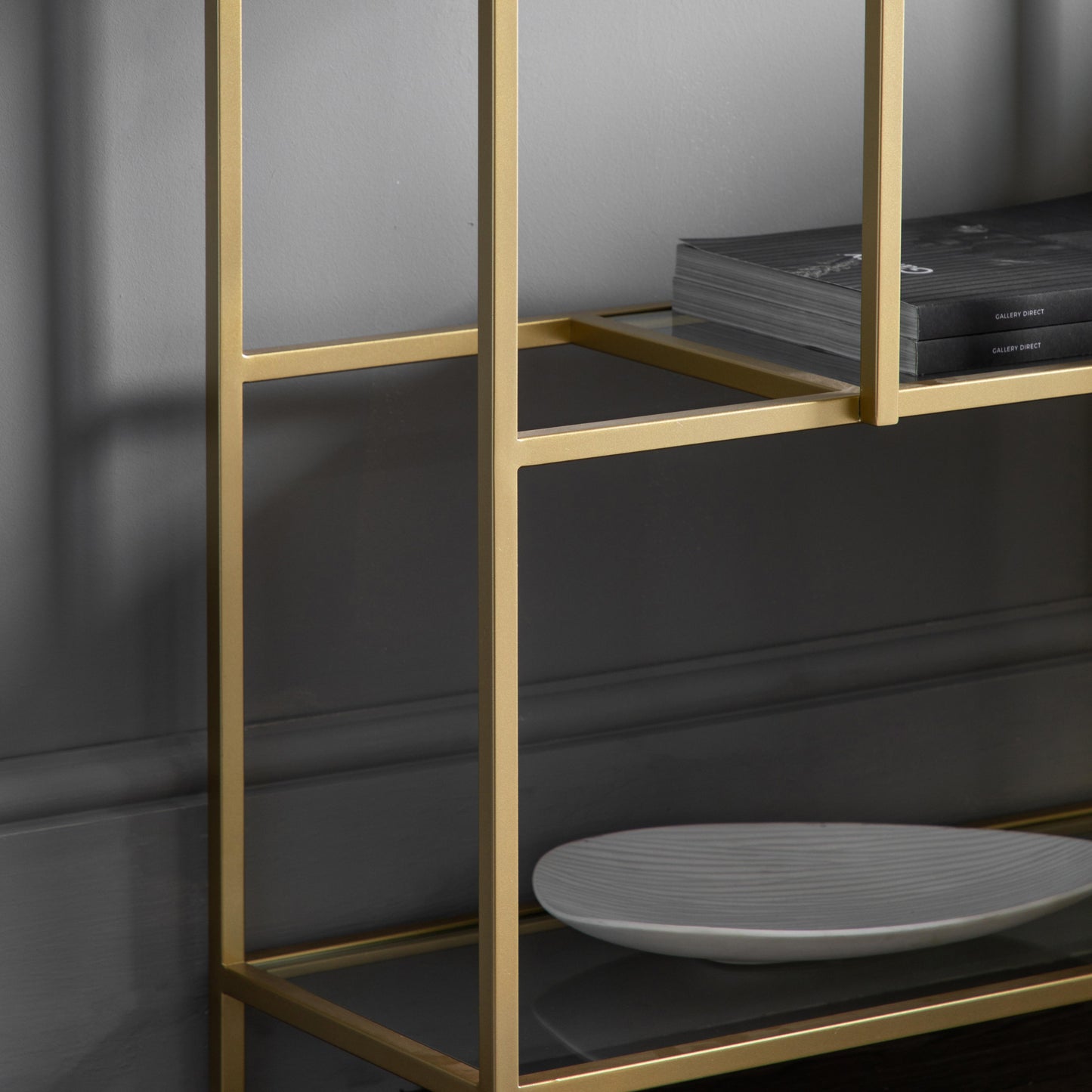 A home furniture display unit from Kikiathome.co.uk featuring a champagne shelf and a plate, perfect for interior decor.