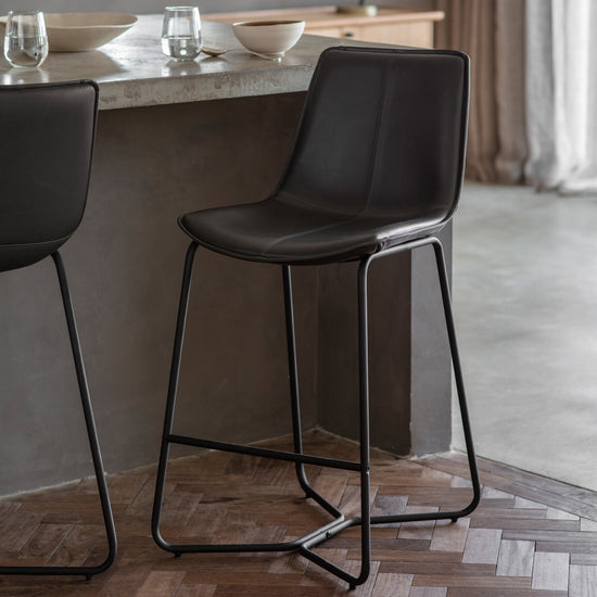 Two Slapton Stool Charcoal (2pk) 480x550x975mm from Kikiathome.co.uk placed on a wooden floor for interior decor.