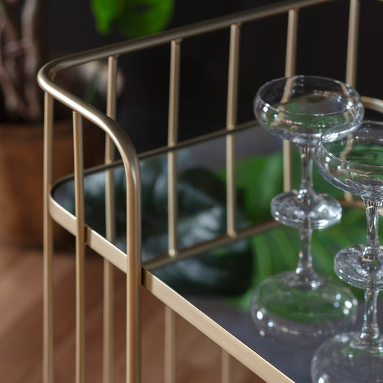A Verna Drinks Trolley with wine glasses, perfect for interior decor and home furniture.