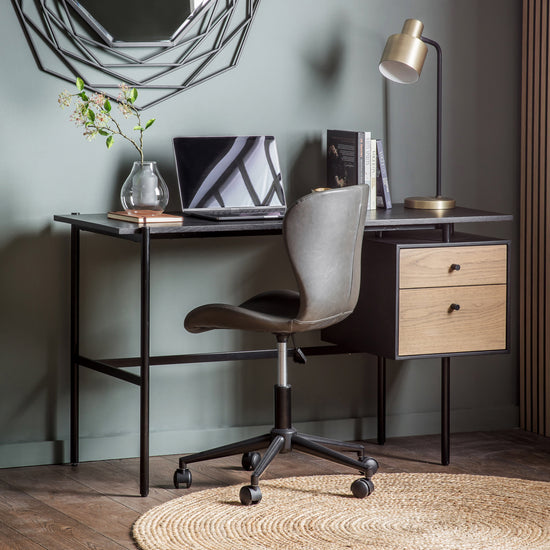 A Prawle 2 Drawer Desk and chair from Kikiathome.co.uk in a room with green walls, adding stylish home furniture to your interior decor.
